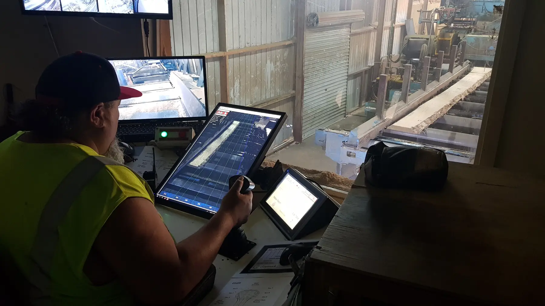 Sawmill operator showing EdgerView on screen